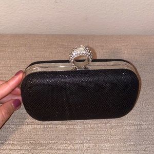 Black clutch with diamond ring handle